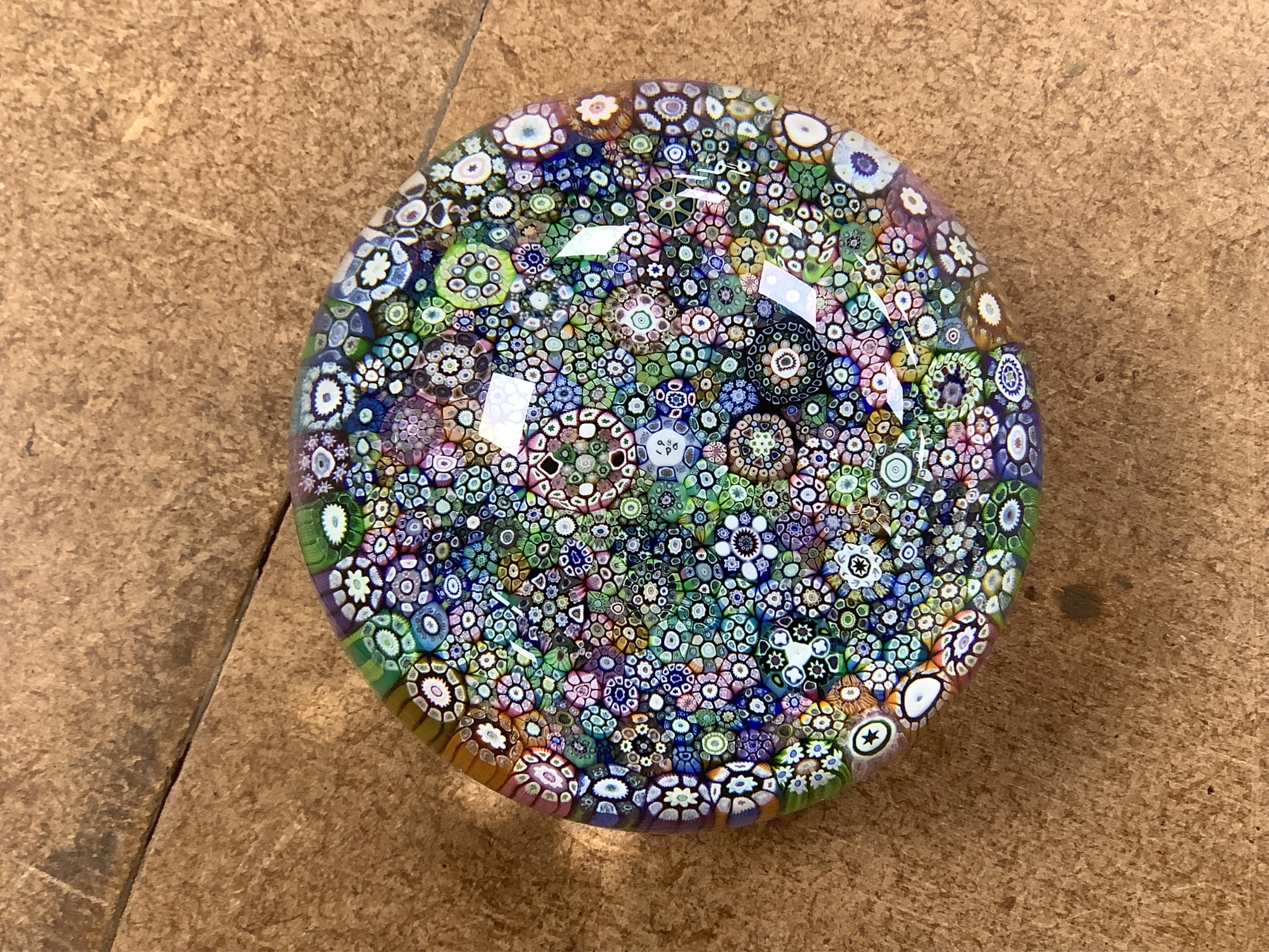 Two boxed Perthshire glass paperweights, the first faceted with latticino twists and complex canes, the second close packed millefiori paperweight, 62/400